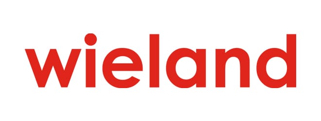 The image shows the word "Wieland" written in bold, lowercase letters in red font on a white sheet metal background.