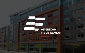 A modern building with various windows is depicted in the background, featuring the logo of American Fiber Cement in the foreground. The logo consists of stylized, horizontal white stripes and text placed centrally over the image of the building's exterior facade cladding.