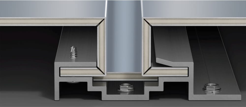 Close-up view of a metal floor expansion joint cover system. The image shows a detailed section of interconnected aluminum profiles with visible screws and bolts, similar to those used in exterior facade cladding. The system illustrates where different floor sections meet and allows for movement and expansion.