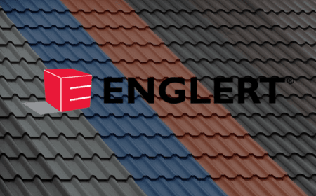 A multi-colored metal roof features alternating rows of grey, red, and blue panels. Overlaid on the image is a red cubic logo and black text "ENGLERT®," showcasing innovative design.