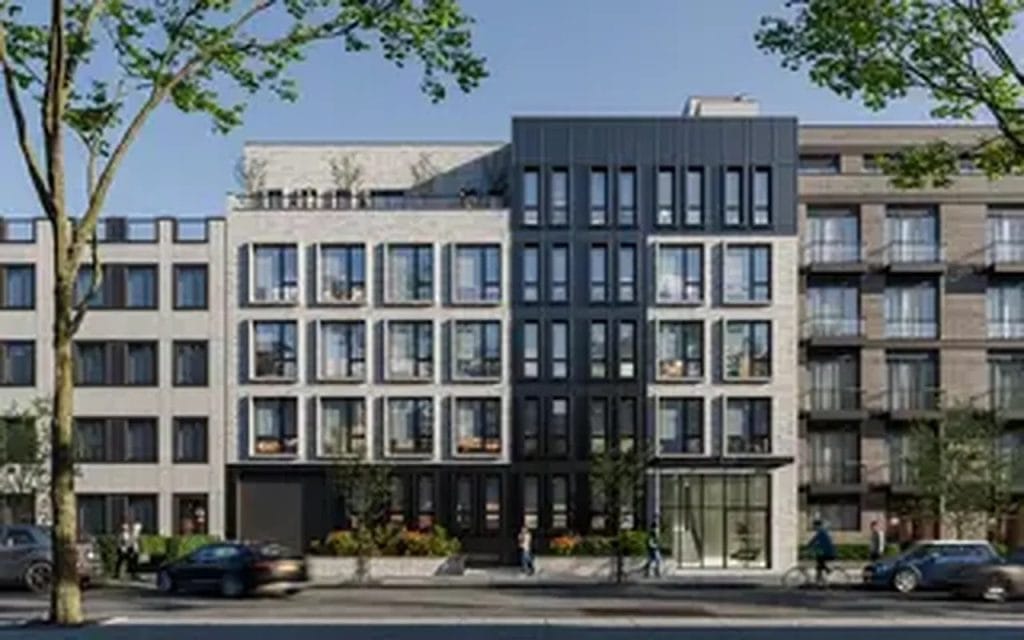A city street view showcases a modern mid-rise apartment building with large glass windows and a mix of light grey and dark grey facade. Pedestrians stroll along the sidewalk, and a few cars are parked in front. Trees with green leaves partially frame the bustling urban scene.